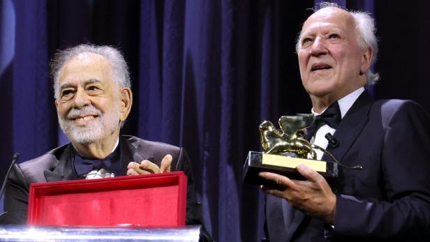 Werner Herzog hält Goldenen Löwen bei 82. Filmfestspielen von Venedig, den ihm Francis Ford Coppola überreicht hat.