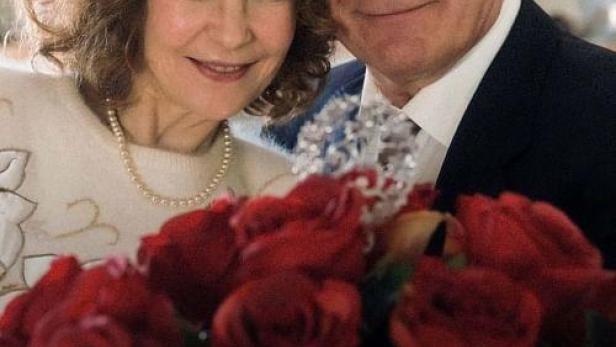 Ein Mann und eine Frau lächeln vor einem Strauß roter Rosen; Filmposter „Der Fall Marianne Voss“.