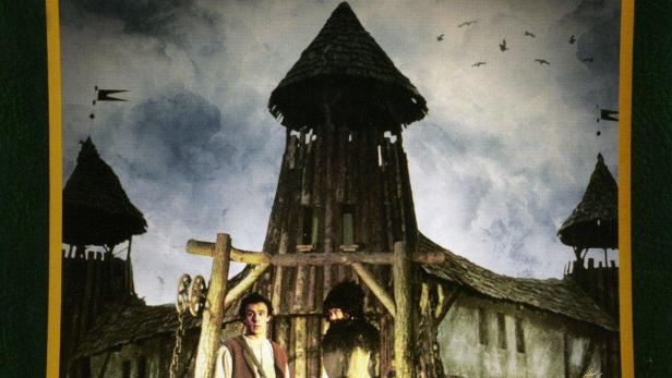 Das Cover des Films „Die Schwarze Mühle“ zeigt zwei Figuren vor einer alten Mühle.