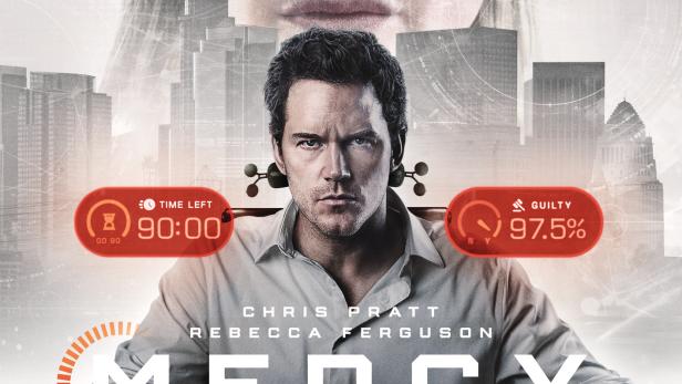 Mann sitzt in futuristischem Stuhl, das Gesicht einer Frau erscheint groß über ihm