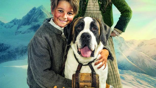 Junge kniet neben Bernhardiner und umarmt den Hund