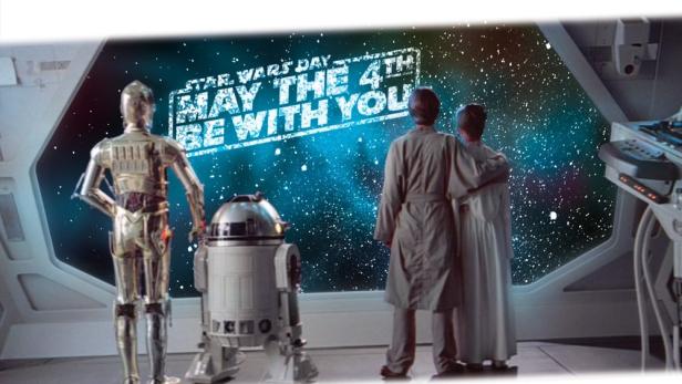 "Star Wars"-Figuren betrachten Schriftzug "May the Fourth be with you"