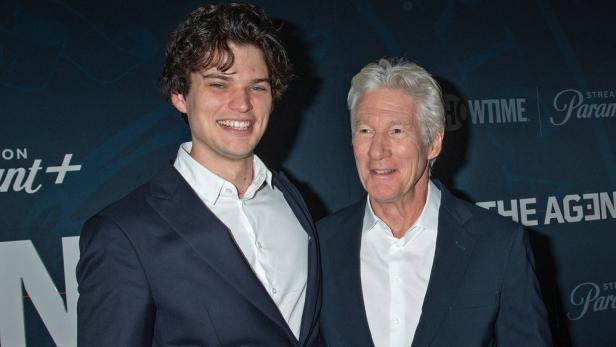 Richard Gere lächelt neben seinem Sohn Homer James Jigme Gere vor einer Paramount+-Hintergrundwand.