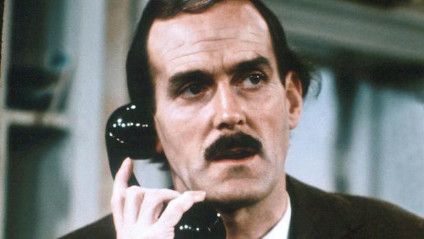 John Cleese studierte in Cambridge und wurde zum bekanntesten Gesicht der Monty Python&#039;s. Er feierte nach seinem Ausstieg 1974 auch mit der TV-Serie &quot;Fawlty Towers&quot; (Bild) als Hoteldirektor Erfolge, und später, gemeinsam mit Michael Palin, in der Kinokomödie &quot;Ein Fisch namens Wanda&quot;.