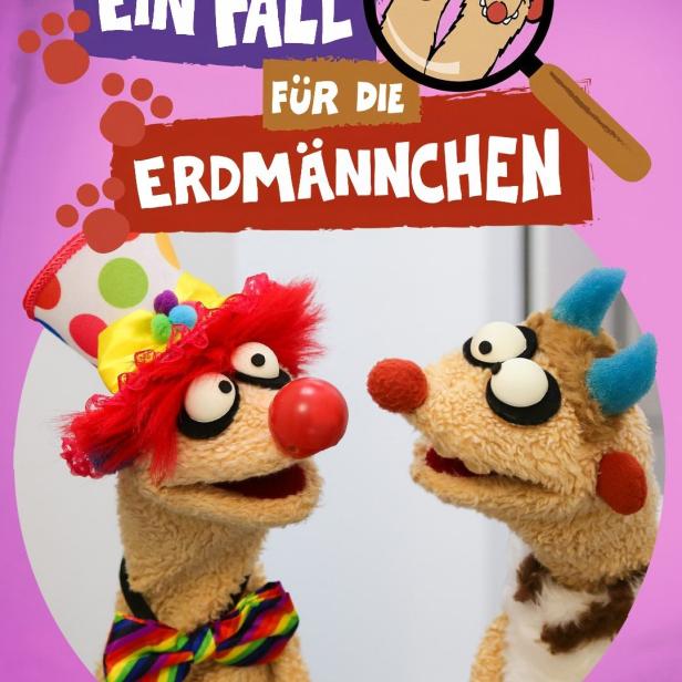 Das Poster für „Ein Fall für die Erdmännchen“ zeigt zwei Handpuppen-Erdmännchen.