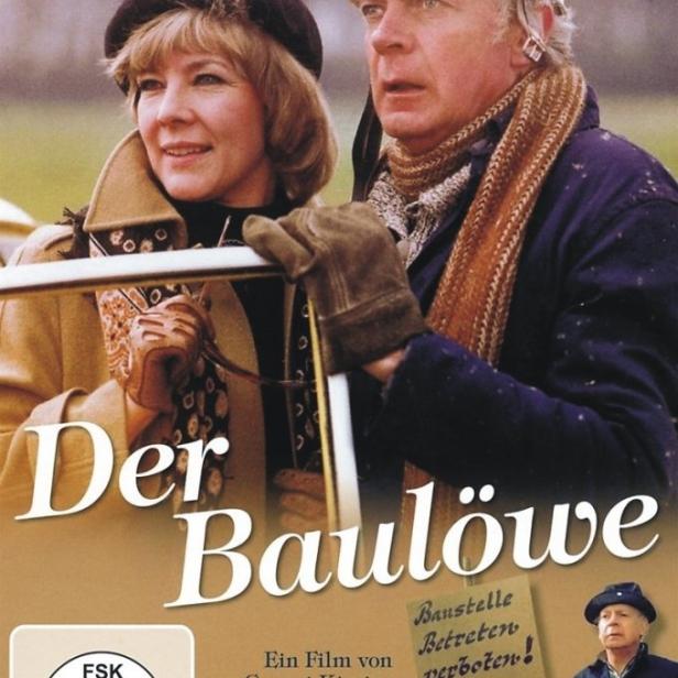Das Filmplakat zu „Der Baulöwe“ zeigt Rolf Herricht mit Bauhelm und eine Frau mit Hut.
