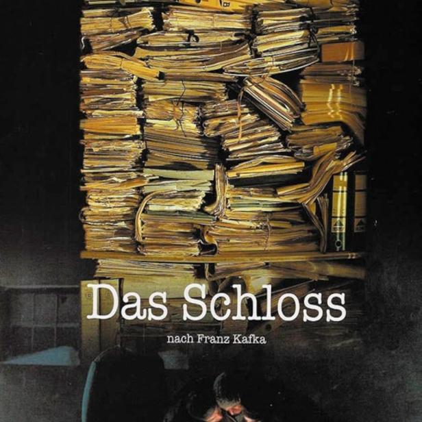 Das Filmplakat für „Das Schloss“ nach Franz Kafka zeigt einen Stapel Akten und drei Personen.