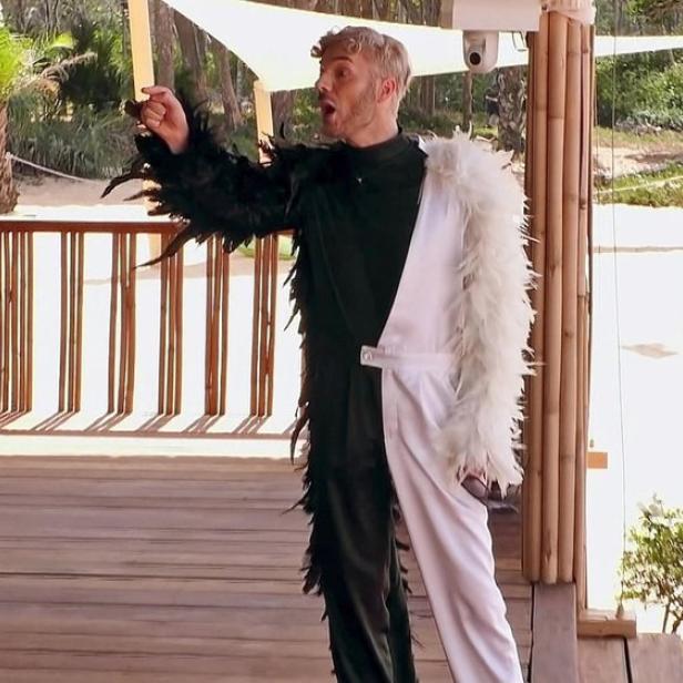 Wütender Sam Dylan auf Hausveranda mit erhobener Faust